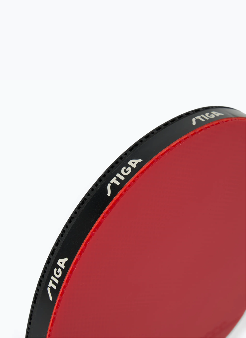 Close-up of STIGA Vision 4-Star table tennis racket blade edge showing black branded edge tape and red rubber surface detail