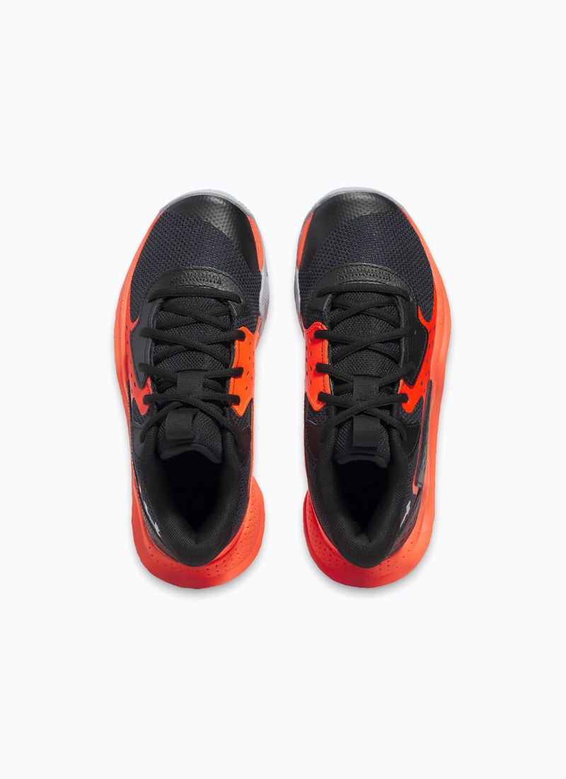 Overhead view of a pair of Black and orange Under Armour Under Armour GS Jet '23 Kids sneaker on a white background