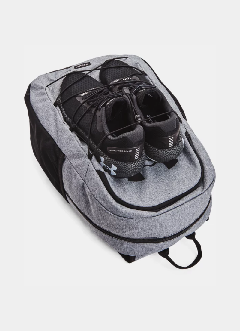 Gray backpack with black shoes inside on a white background
