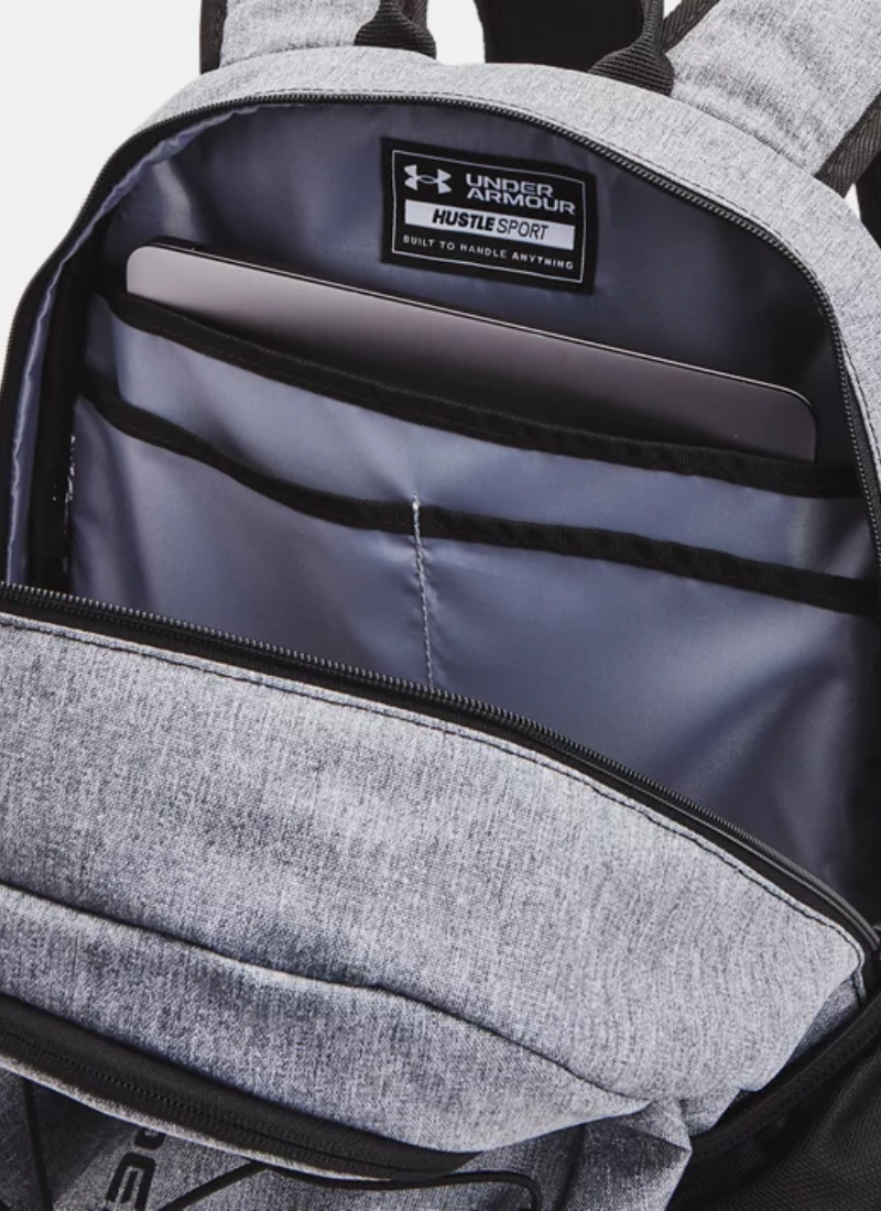 Gray backpack unzipped and open with Under Armour logo on a white background