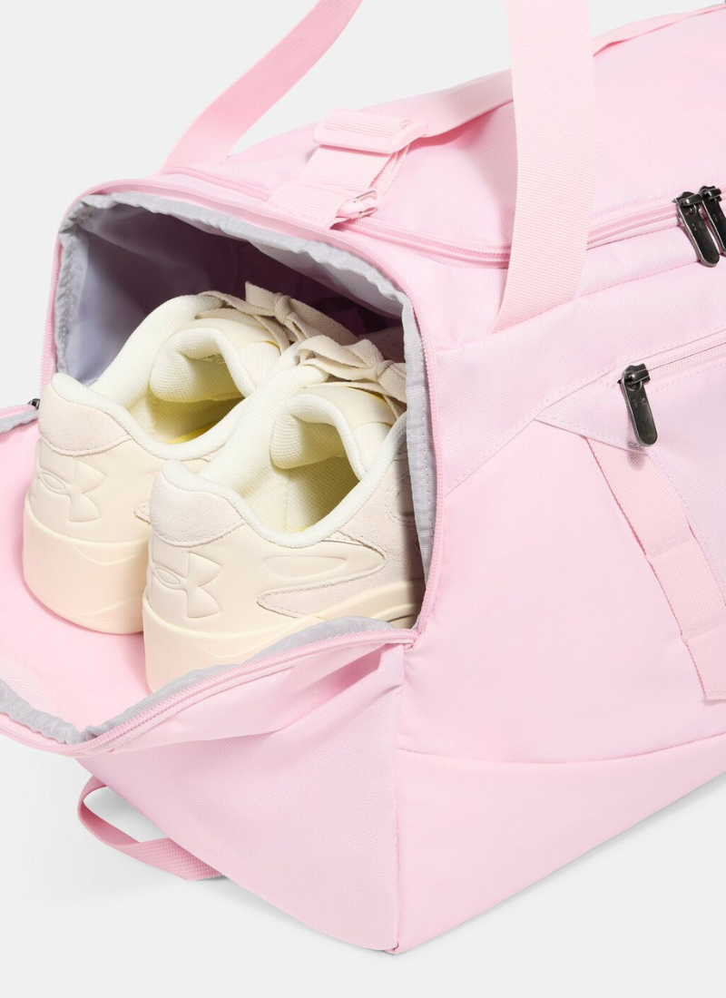Pink duffel bag with a white sneaker inside on a light gray background
