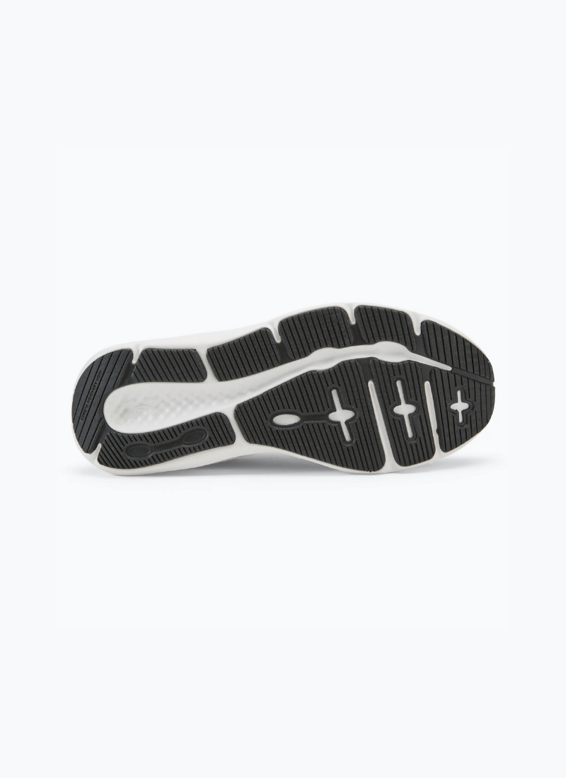 Black and white sole of a single shoe of Under Armour Women's Charged Pursuit 3 against a white background