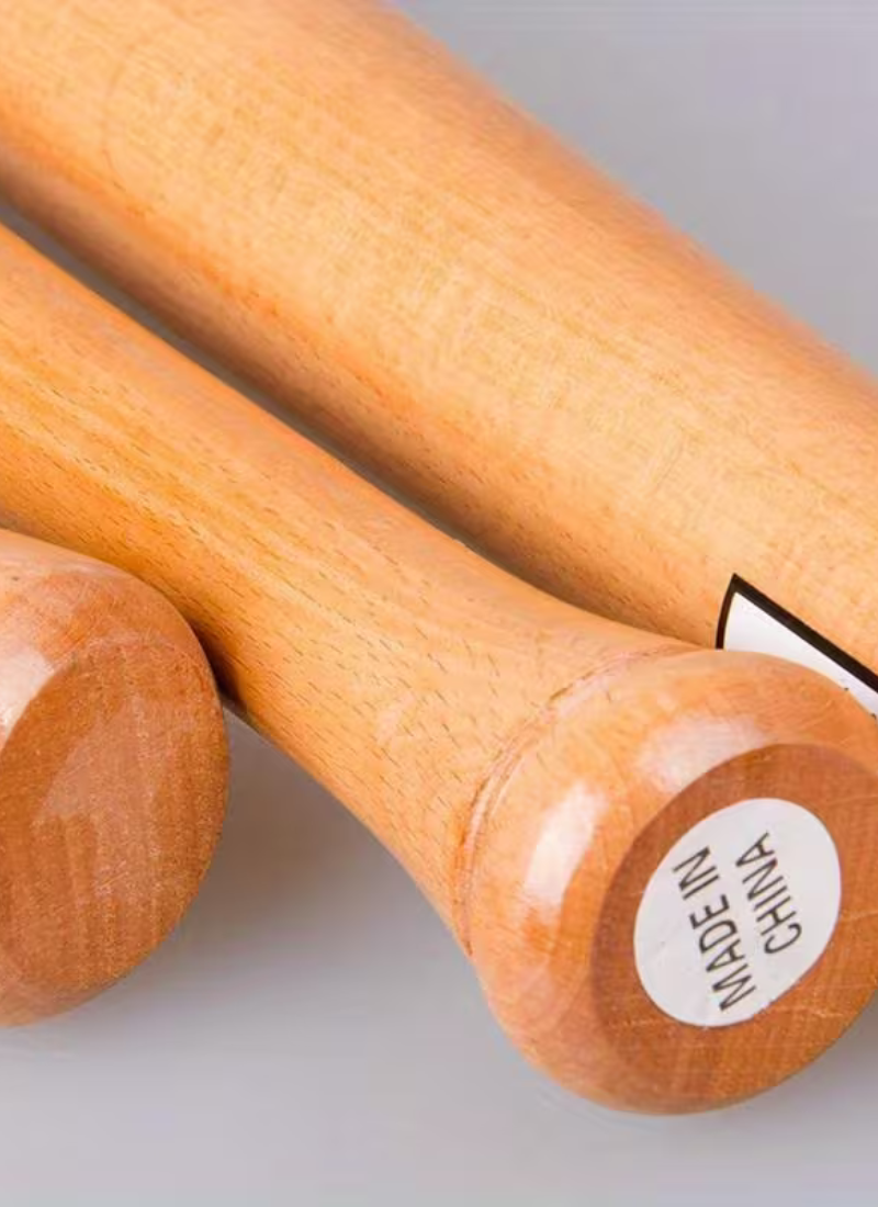 Knob end of natural hardwood baseball bat showing lacquered wood grain finish