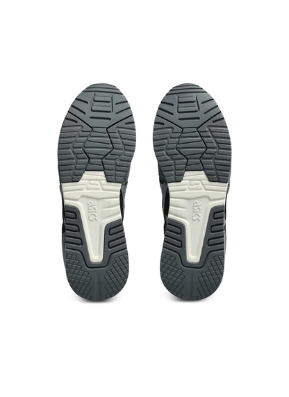 Underside bottom view of the Asics Lyte Classic Sneaker outsoles featuring dark grey tread patterns with off-white central branding sections.
