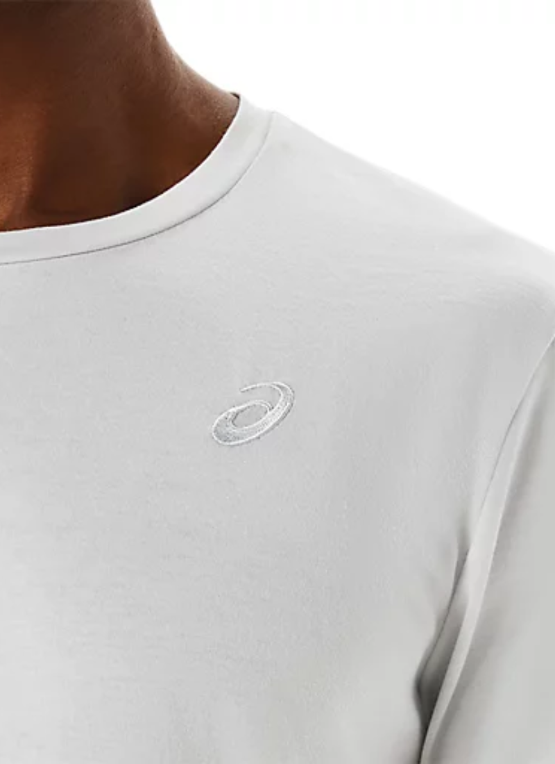 Close-up of a light gray t-shirt with an embroidered Asics logo on the chest.