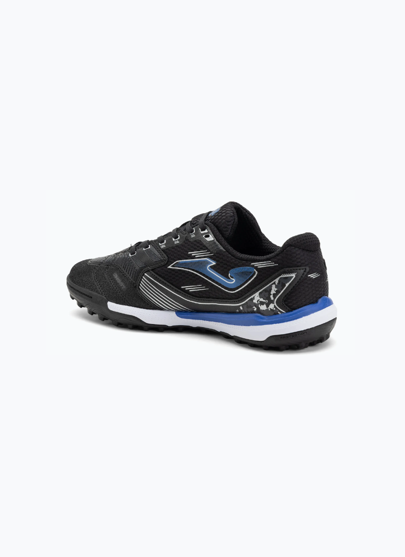 Joma Liga 5 men's turf football boots angled rear view showing black mesh upper, royal blue Joma logo, camo-print heel panel, and multi-stud outsole