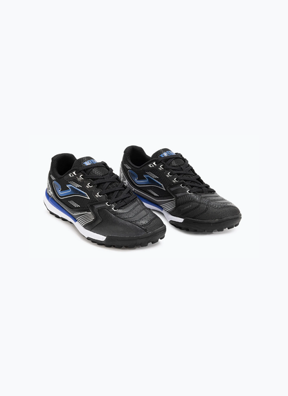 Pair of Joma Liga 5 men's turf football boots showing black synthetic upper, royal blue Joma logo, and white midsole