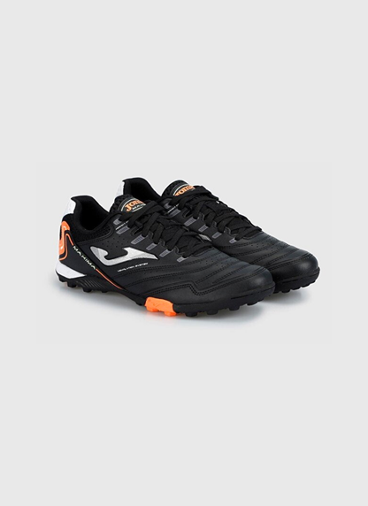 Front three-quarter view of a pair of black Joma Maxima 2301 turf football shoes with stitched leather forefoots, silver side logos, and bright orange outsole accents.