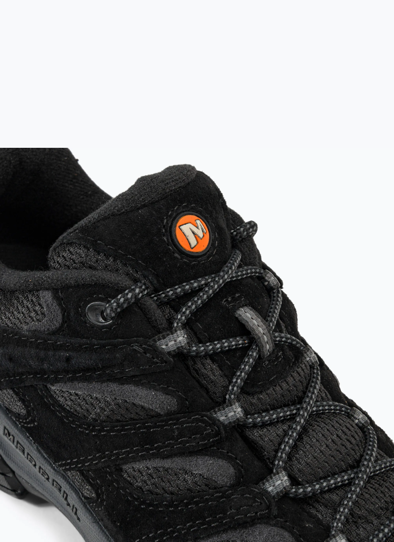 Close-up view of the tongue and lacing structure of the Merrell Moab 3 Vent, showing the woven patterned laces and circular orange 'M' logo badge.