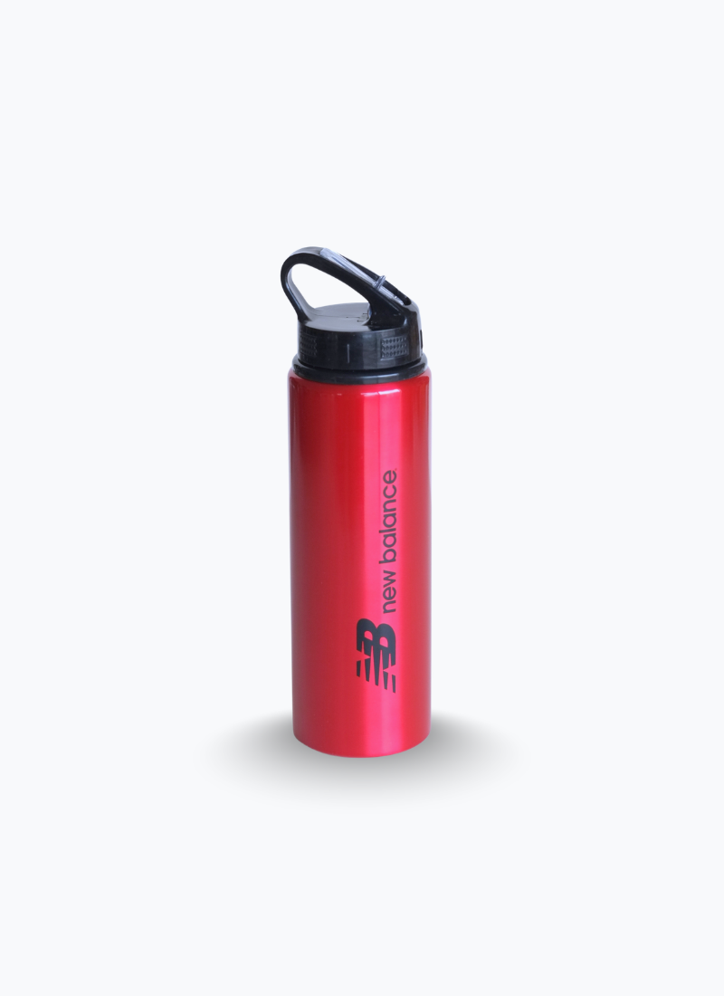 New Balance red metal sports water bottle, front view with black lid and carry loop, flip-up straw spout closed.