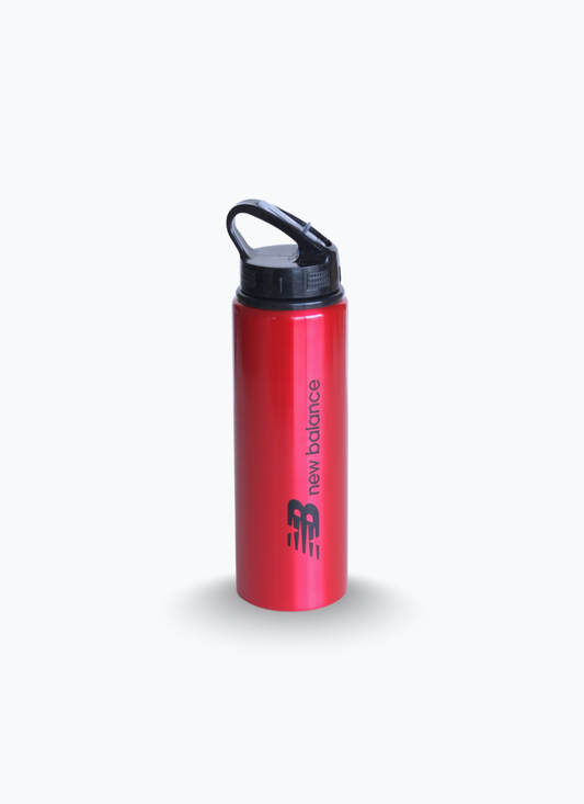 New Balance red metal sports water bottle, front view with black lid and carry loop, flip-up straw spout closed.