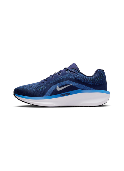 Medial side view of the Nike Winflo 11 running shoe in navy blue, displaying the inner upper mesh weave, small silver Swoosh, and Cushlon branding on the midsole.
