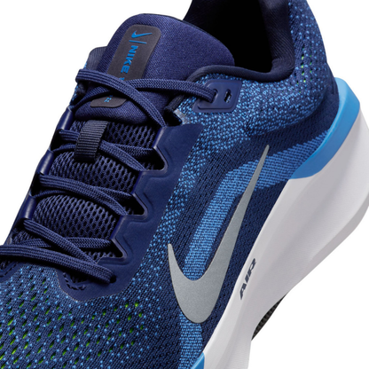 Close-up lateral angle of the Nike Winflo 11 forefoot and lace unit, showing the engineered navy mesh upper, eyestays, silver Swoosh, and white midsole.