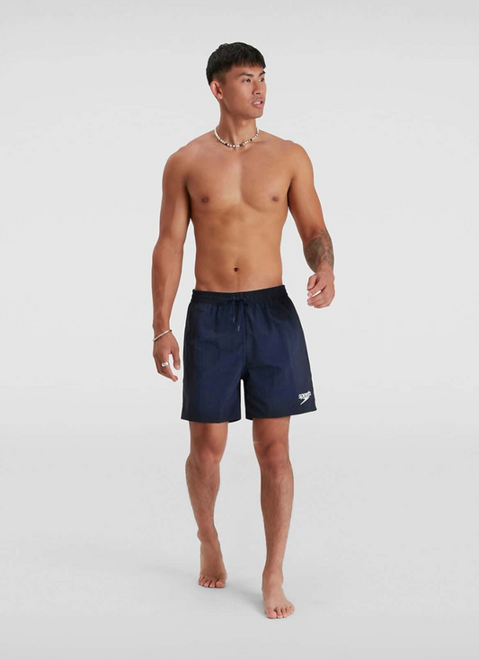 Man wearing navy swim shorts on a white background