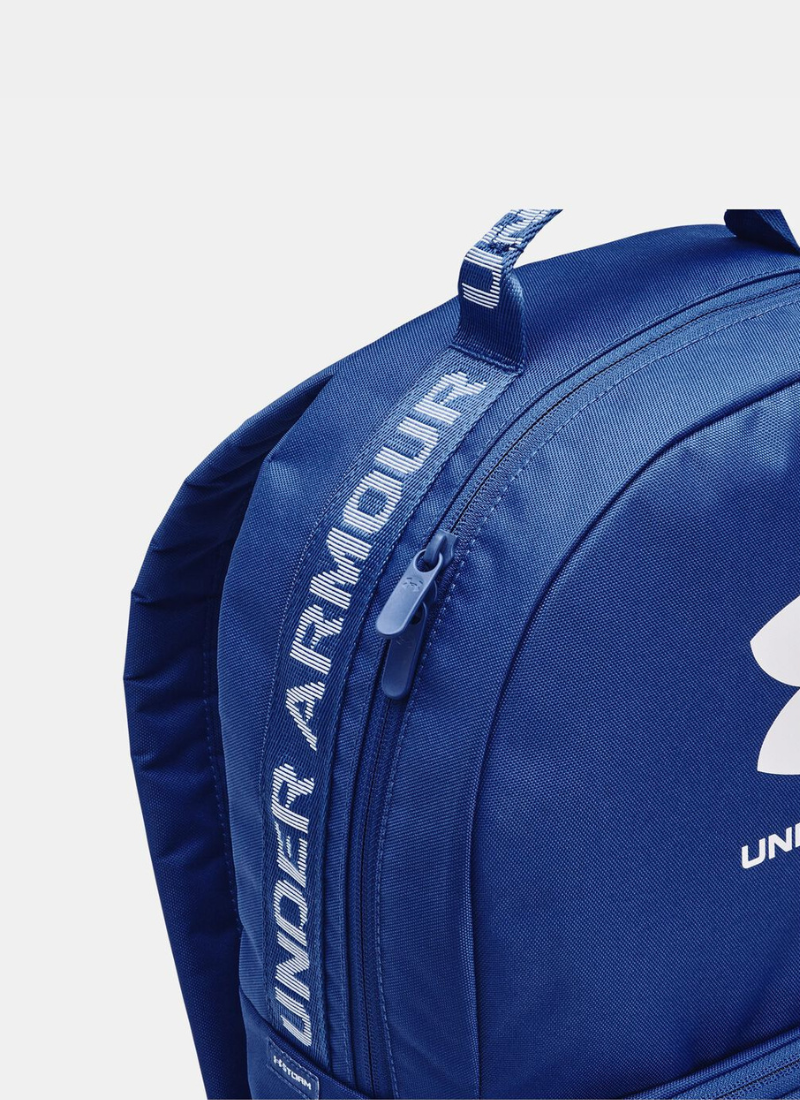 Blue Under Armour backpack on a light gray background