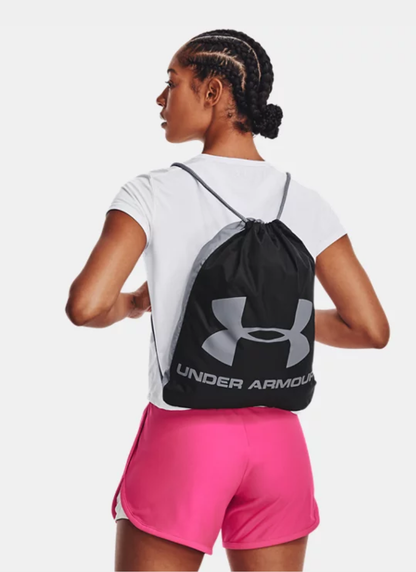Person wearing a black Under Armour drawstring bag on a white background