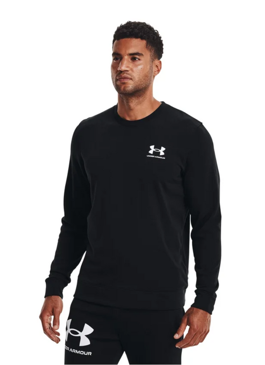 Man wearing a black Under Armour long-sleeve shirt and shorts on a white background