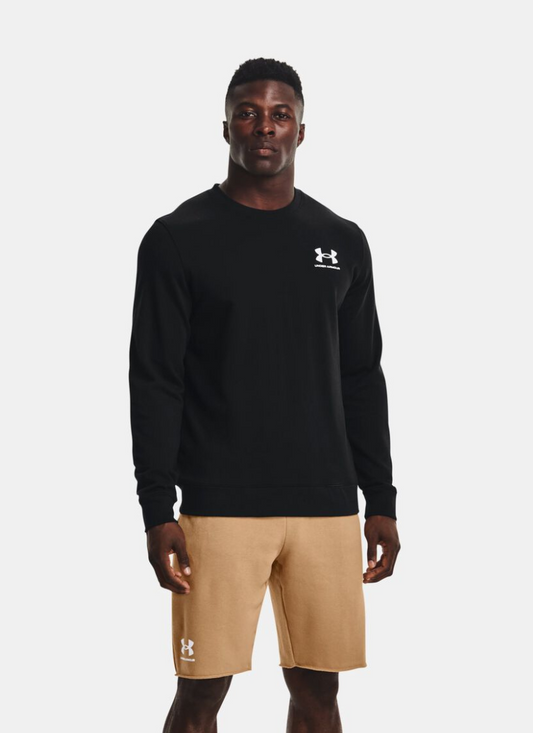 Person wearing a black Under Armour sweatshirt and beige shorts on a white background