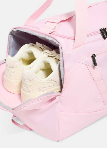 Pink duffel bag with a white sneaker inside on a light gray background