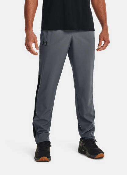 Person wearing gray Under Armour pants on a white background