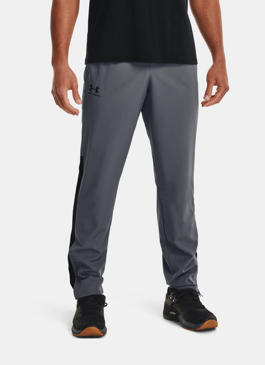 Person wearing gray Under Armour pants on a white background