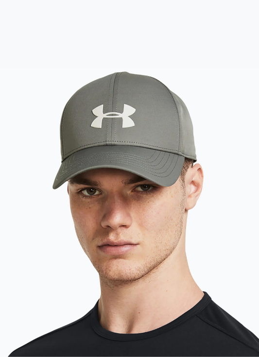 Man wearing a clay green Under Armour cap on a white background