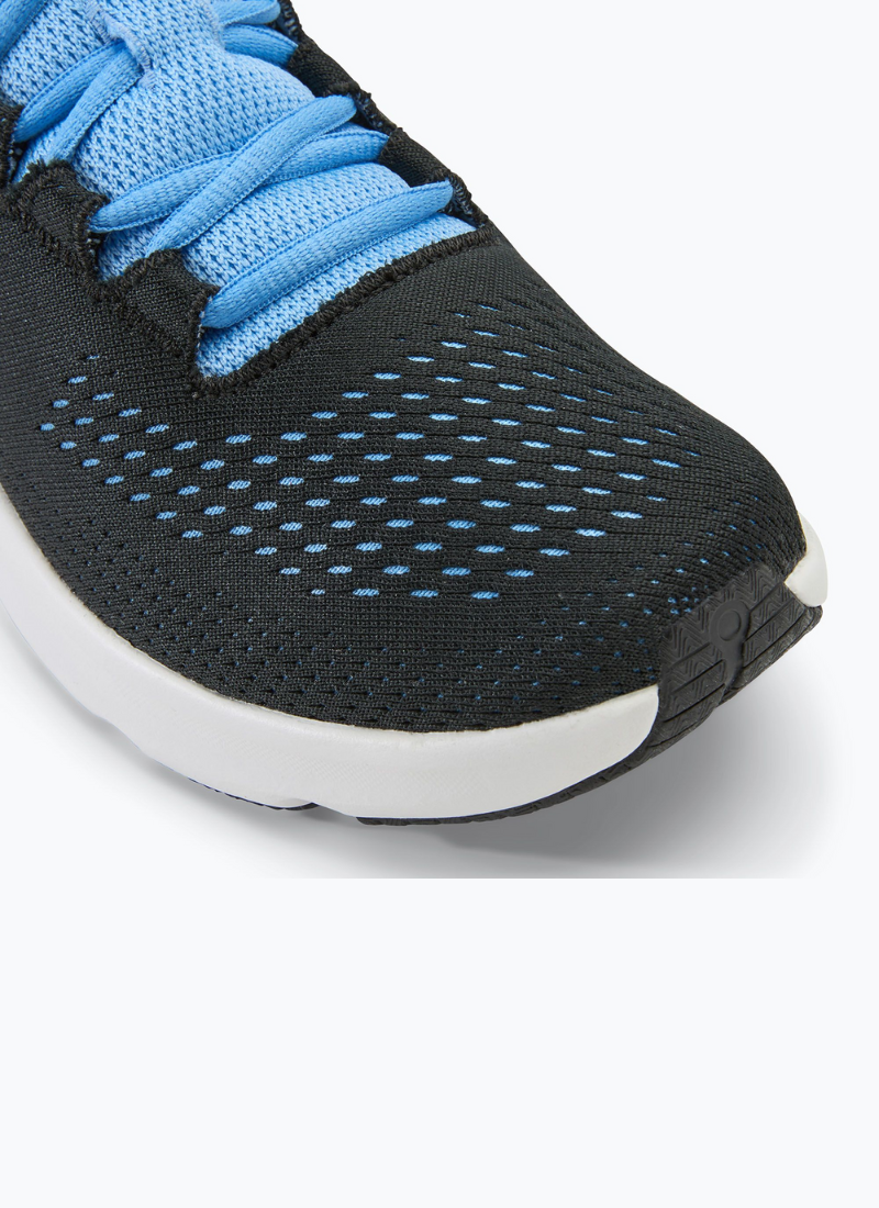 Close view of a pair of Under Armour Women's Charged Pursuit 3 in black and blue against a white background