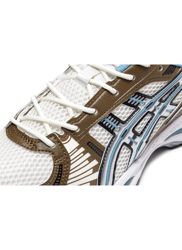 Close-up of Asics Gel-Kayano 12.1 Cream/Stillwater forefoot, detailing mesh upper, olive overlays, and light blue trim stitching.