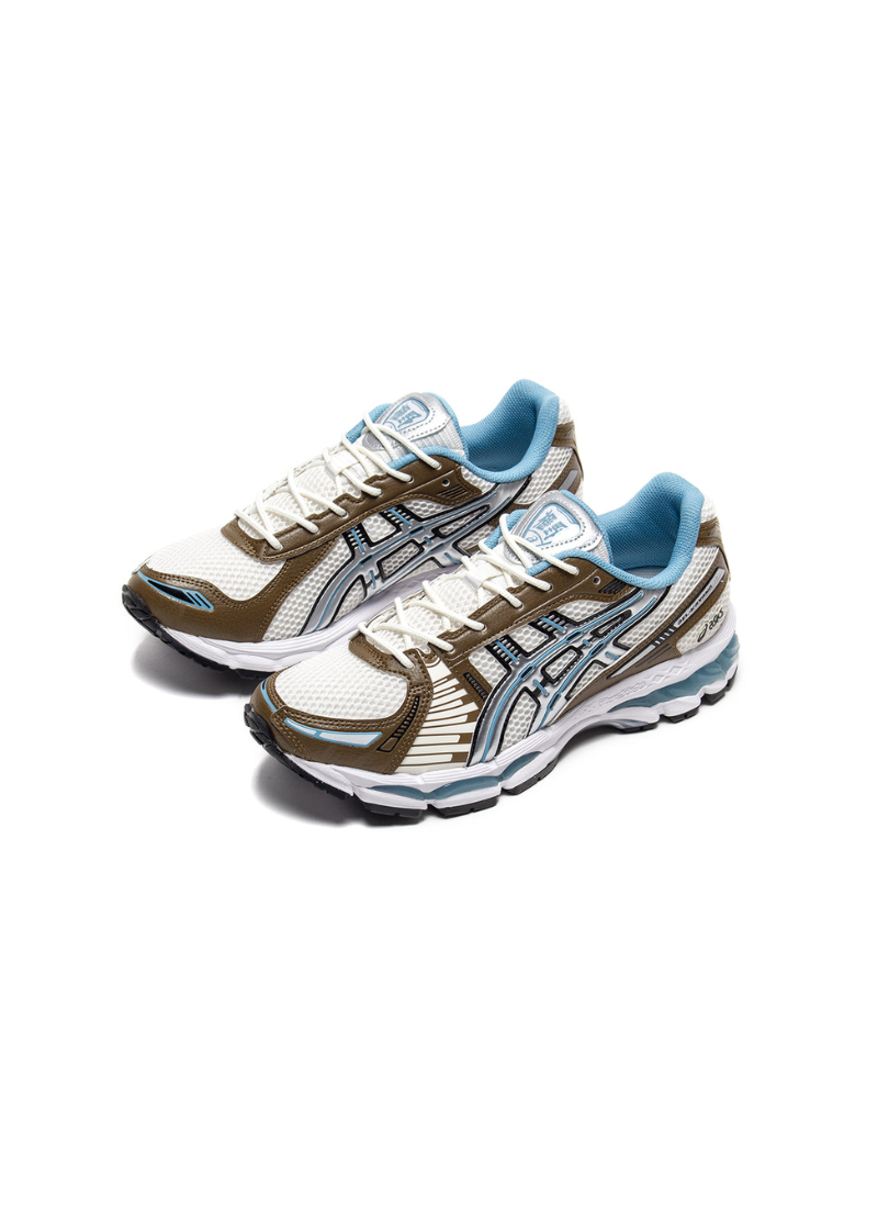 Pair of Asics Gel-Kayano 12.1 sneakers in Cream/Stillwater, angled front view on white background.