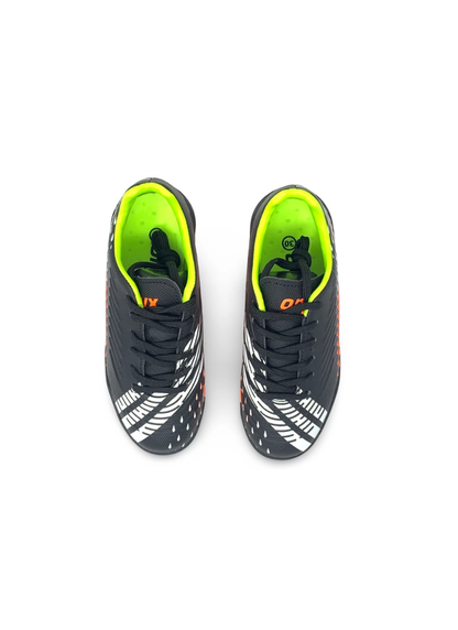 Top-down view of a pair of black kids' turf football shoes with black laces and lime green interior